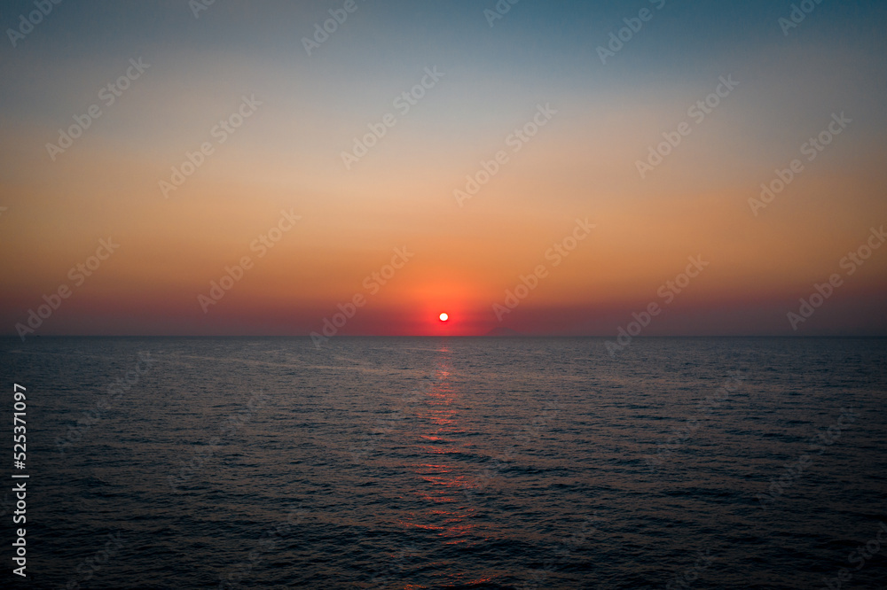 Golden sunset in the italian sea from the water