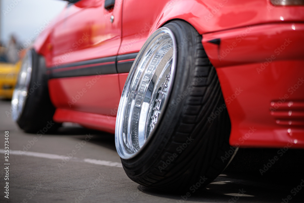 Tuned red sport car wheel, close up. Low rider sport auto Tuned red sport car wheel, close up. Low rider sport auto