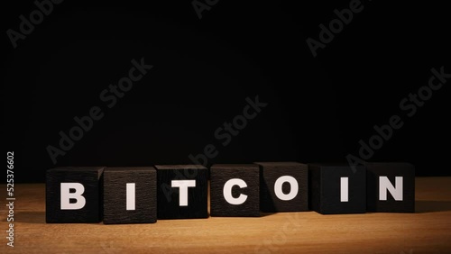 Bitcoin wooden blocks falling on table and dissapear after while. Seamless loop of 3D render concept animation. photo
