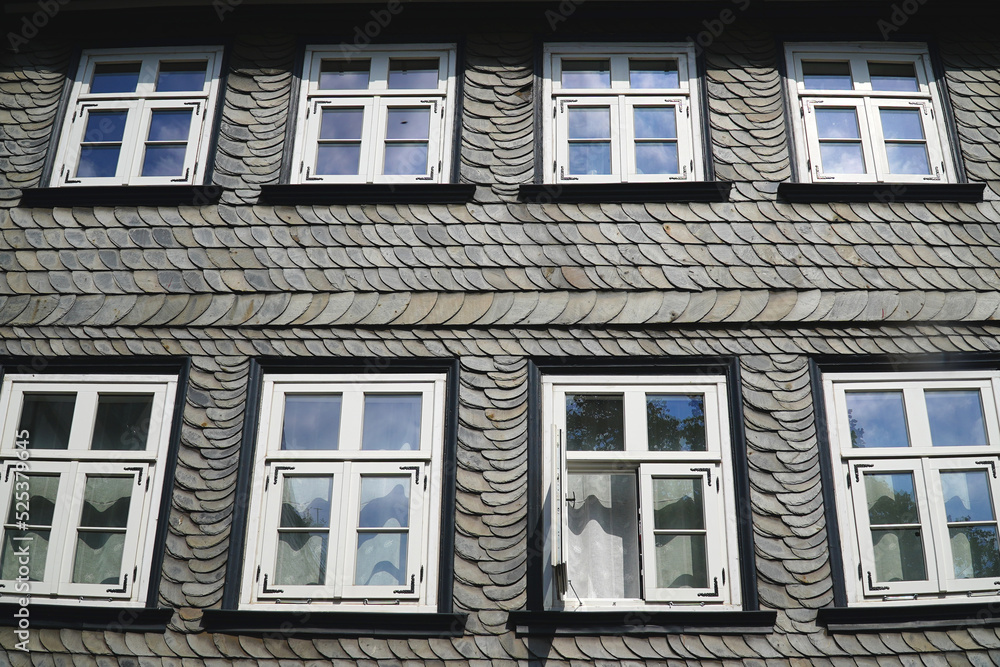 The North German mountains are rich in natural slate resources, which has been mined there. The typical gray house facades are a sign of these rich shale deposits. Goslar, Harz Mountains, Germany.