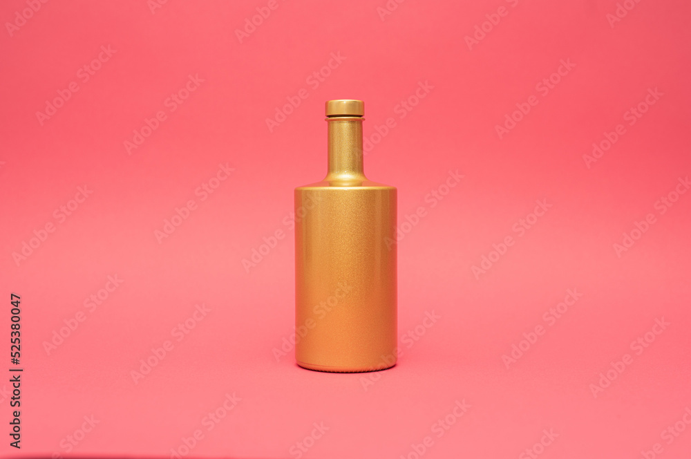 golden glitter bottle on pink background golden glitter bottle on pink background