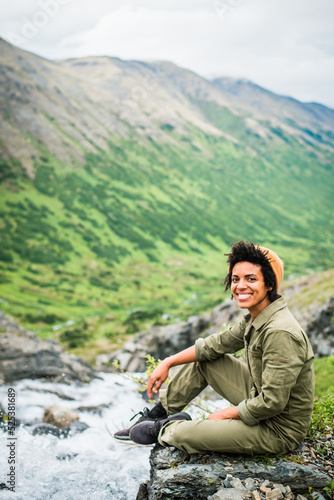 person sitting on a rock with beautiful view