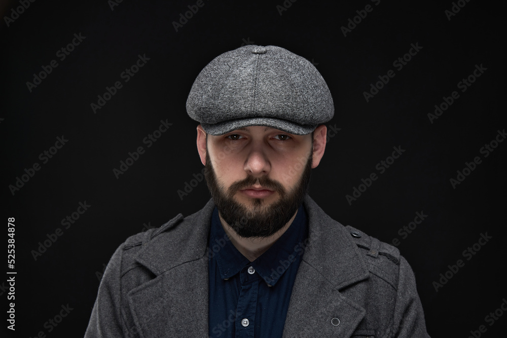 Man with a beard on a dark background, English classic clothes Man with a beard on a dark background, English classic clothes