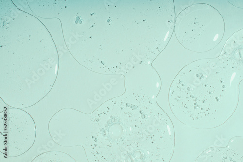 Top view of liquid cosmetics gel with bubbly structure on pastel cyan background.Good as cosmetic mockup.