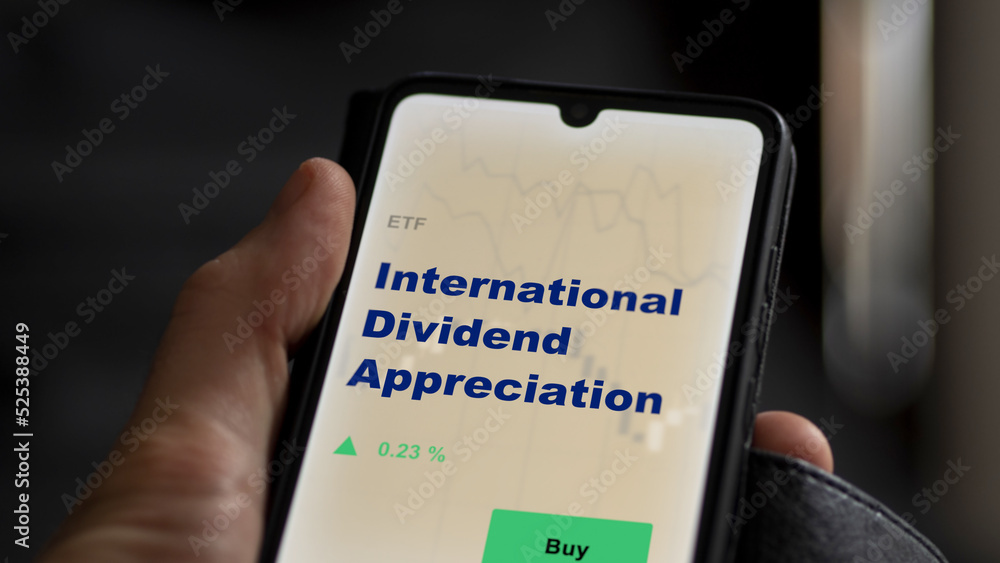 An investor's analyzing the trading-leveraged commodities etf fund on screen. A phone shows the ETF's prices stocks to invest An investor's analyzing the trading-leveraged commodities etf fund on screen. A phone shows the ETF's prices stocks to invest