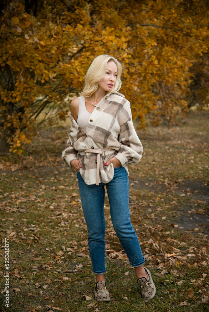 beautiful smiling blond sexy girl with long hair walking in autumn forest beautiful smiling blond sexy girl with long hair walking in autumn forest