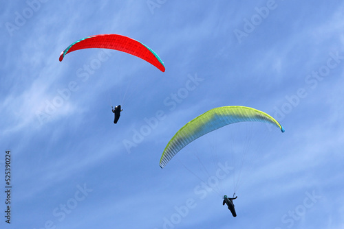 Paragliders in a blue sky 