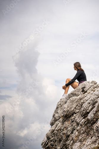 Pretty rock climber lady on a rock 