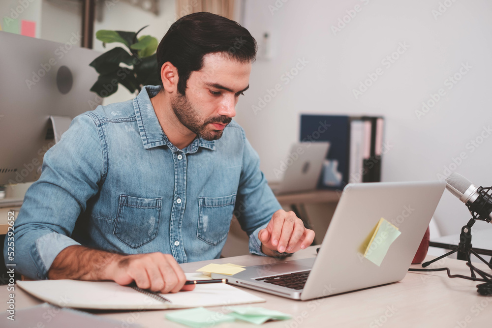 Portrait of serious businessman with laptop sitting at desk in office. Cheerful casual caucasian employee, Handsome businessman using mob phone. successful business working at office. mobile phone. Portrait of serious businessman with laptop sitting at desk in office. Cheerful casual caucasian employee, Handsome businessman using mob phone. successful business working at office. mobile phone.