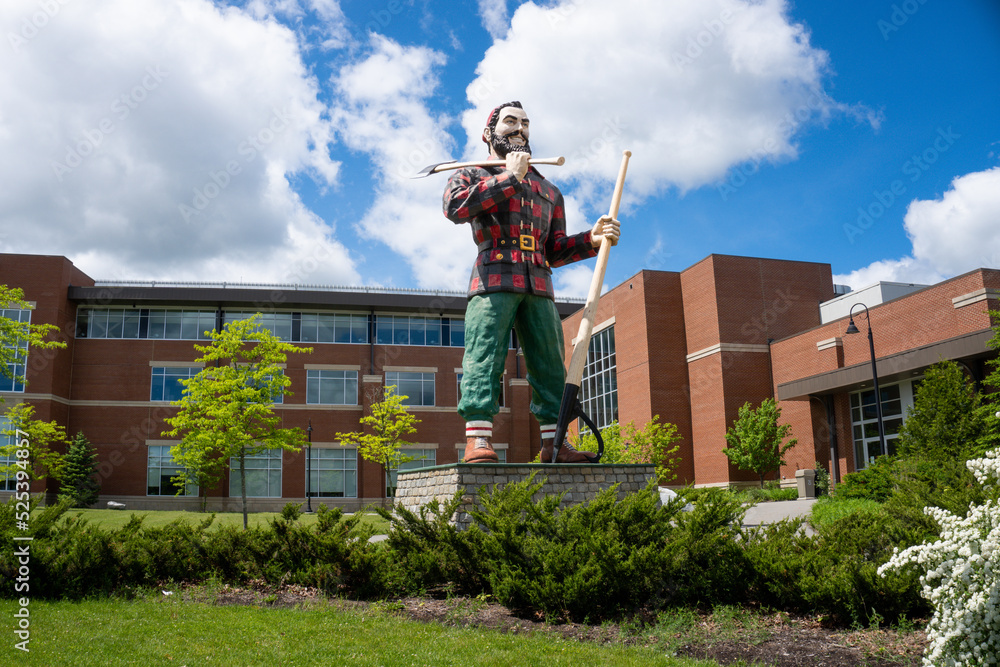 Bangor, Maine: Paul Bunyan holding double-sided ax and lumberjack's peavey.  Giant statue in town claiming to be birthplace to the legendary lumberjack.  Photos | Adobe Stock