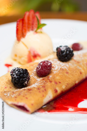 Crepe pancakes with strawberries and ice cream