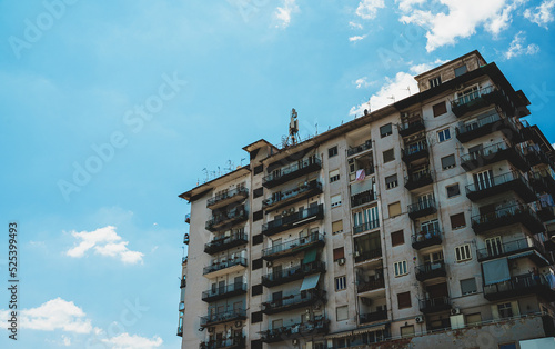 Italian apartment building with balconies and windows.