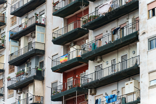 Italian apartment building with balconies and windows. photo