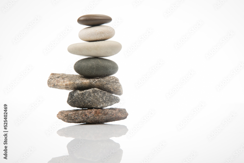 pyramid of stacked stones on a white background. stabilization and balance in life pyramid of stacked stones on a white background. stabilization and balance in life