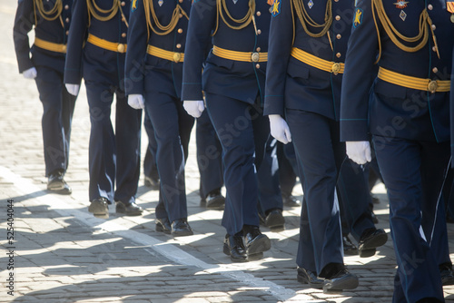 Close-up of soldiers legs dressed in army camouflage.A straight line of boots on the icy parade ground.Concept: military men.Russia