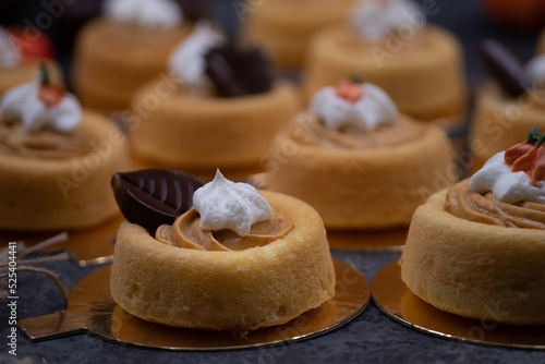 Cake shells filled with pumpkin spice cream, decorated  with chocolate leaves and little royal icing pumpkins photo