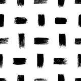 Dashes and short lines seamless pattern. Hand drawn geometric ornament with vertical and horizontal small brush strokes. Weaving motif, simple structure of black brush strokes. Grunge ink texture