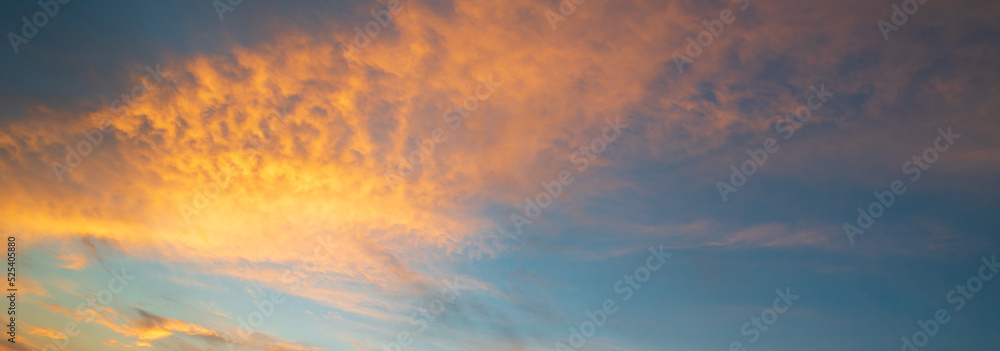 Beautiful pastel cloudy sunset. Dramatic sky with amazing colorful clouds against deep blue