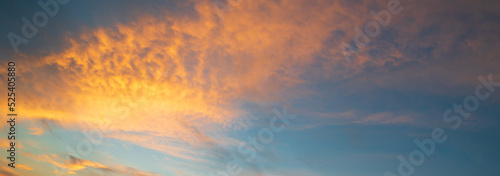 Beautiful pastel cloudy sunset. Dramatic sky with amazing colorful clouds against deep blue