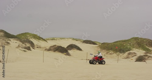 ATV riding along dunes at Oceano Dunes SVRA at Pismo Beach, California photo