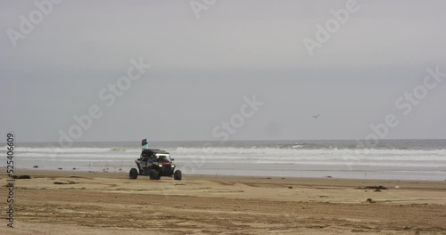 ATV riding along beach at Oceano Dunes SVRA at Pismo Beach, California photo