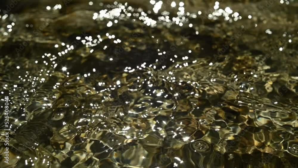 Sunlight reflections of the water in a mountain riverbed (slow motion) Sunlight reflections of the water in a mountain riverbed (slow motion)
