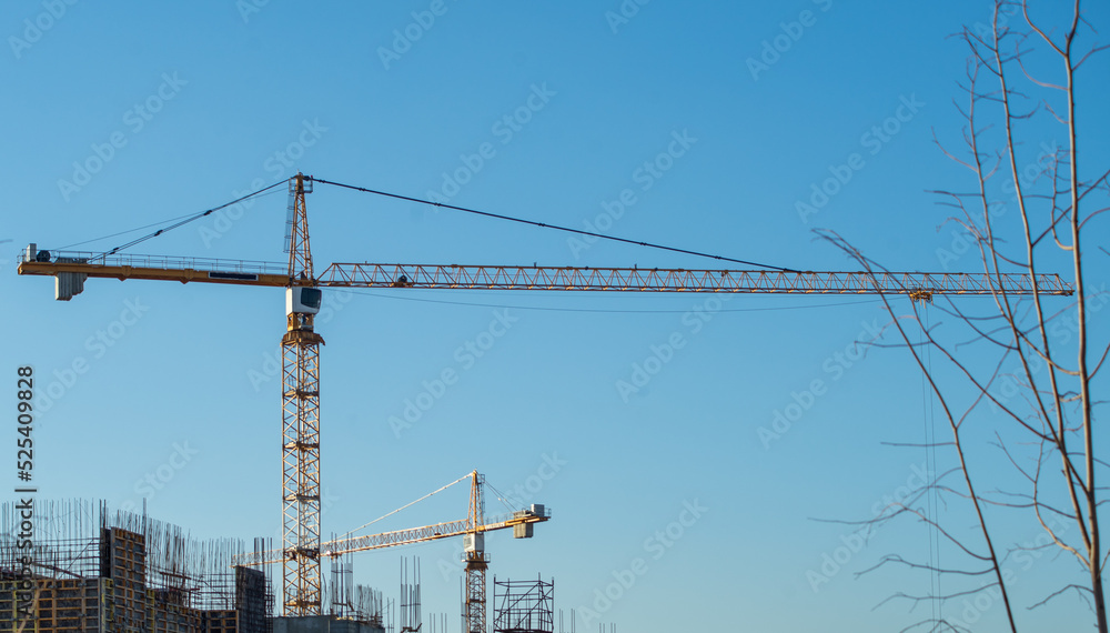 Tower cranes on the construction site of a multi-storey residential building