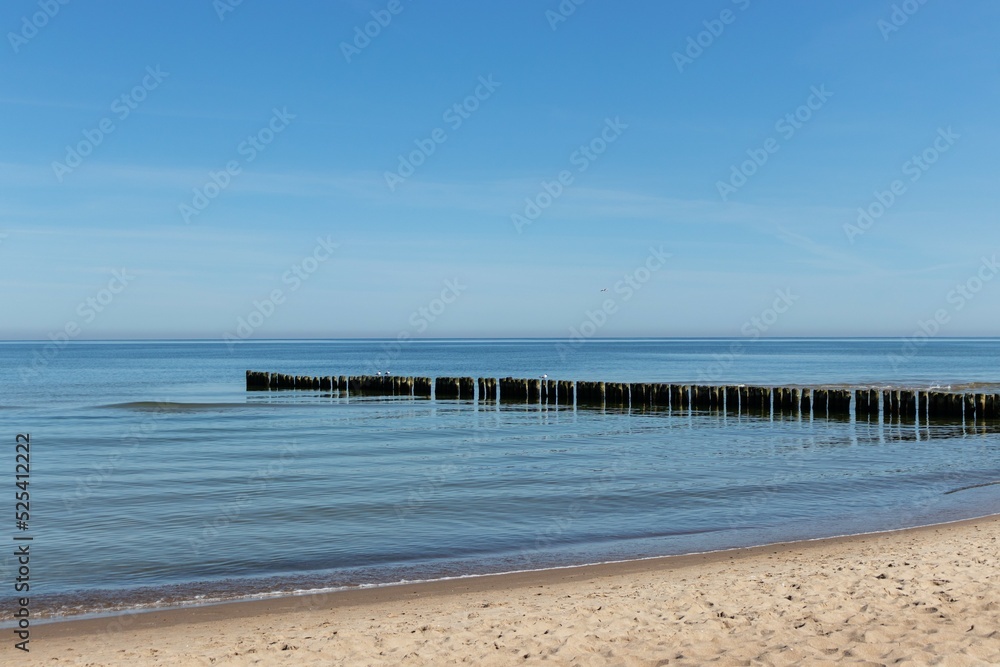 beach with breakwater in the sea