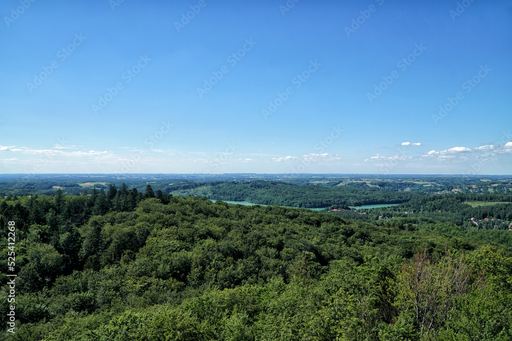 Kashubia landscape aerial view. View on Ostrzyckie Lake from observation tower located at the top of the Wiezyca hill on the  in summer. Hills covered green forests with lakes. Kashubia, Poland.