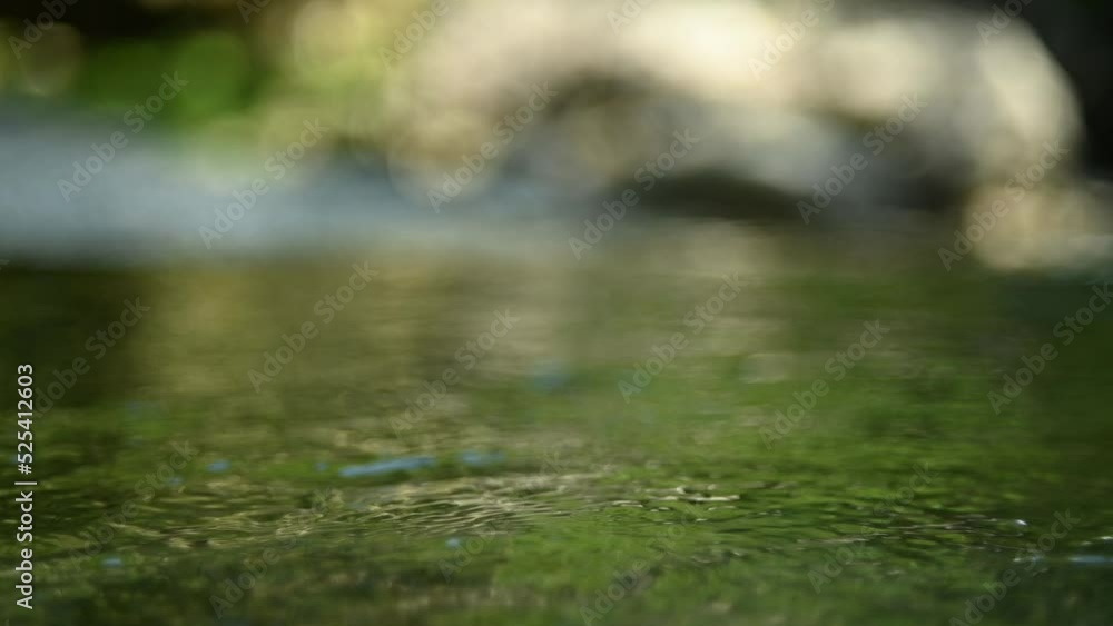Green water in a natural pool of a mountain river (slow motion, bokeh) Green water in a natural pool of a mountain river (slow motion, bokeh)