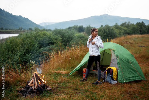 Positive young woman enjoying of the camping © WellStock