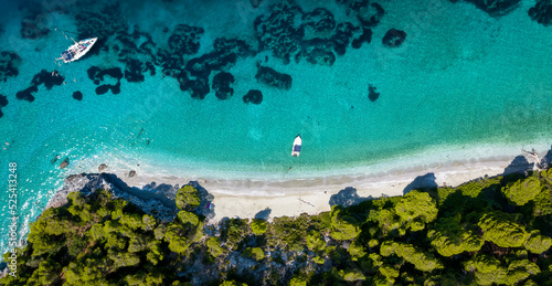 Fototapeta Naklejka Na Ścianę i Meble -  Aerial view of the beautiful coast of Skopelos island with thick pine tree forest, fine sandy beaches and emerald, turquoise sea, Sporades, Greece