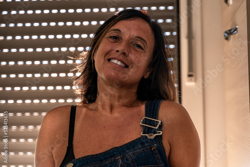 Fotografie image of a beautiful middle aged woman posing in her apartment - Concept about b