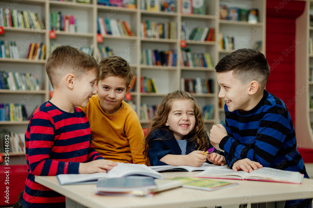 school children in the library reading books, doing homework, prepare a school project for lessons school children in the library reading books, doing homework, prepare a school project for lessons