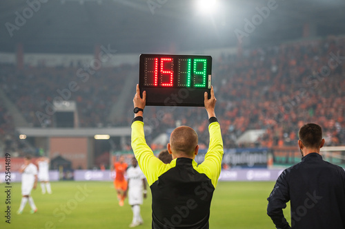 Fotografía Man shows players substitution during soccer match.