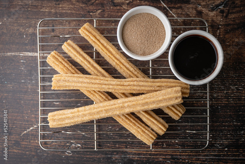 churros with chocolate sauce and cinnamon powder