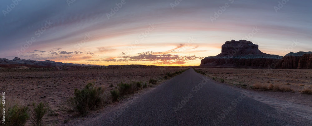 Scenic Road in Red Rock Mountains in the Desert at Colorful Sunrise. Spring Season. Goblin Valley State Park. Utah, United States. Nature Background Panorama