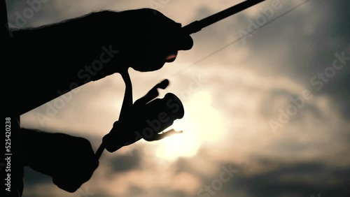 a man is fishing on the lake. sunset