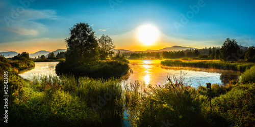The tranquil vibrant moody sunrise landscape of pond and forest at Willband Creek Park in Abbotsford, British Columbia, Canada photo