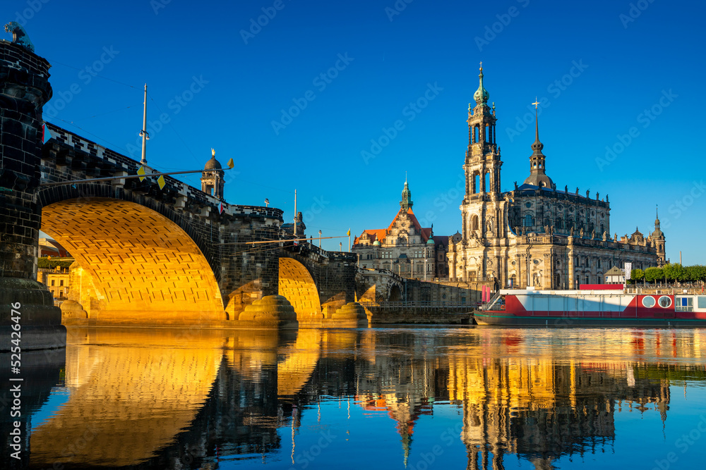 Augustus Bridge and Cathedral of the Holy Trinity with reflections in the river Elbe. Dresden, Saxony, Germany