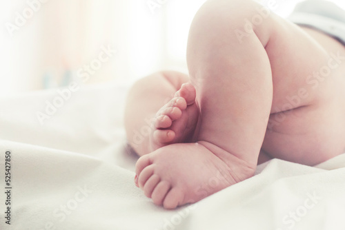 photo with newborn foot in pastel color
