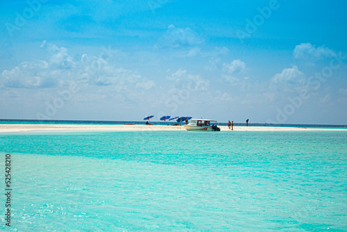beach in the maldives island and speedboat in turquoise color