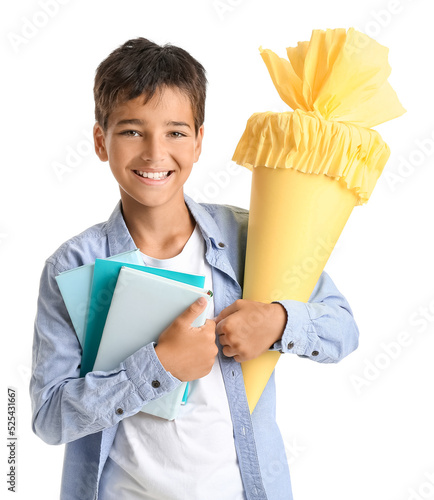 Happy young boy holding sch...