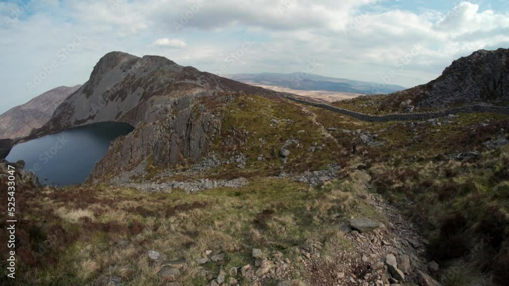 A backpacker on a mountain trail in Wales UK A backpacker on a mountain trail in Wales UK