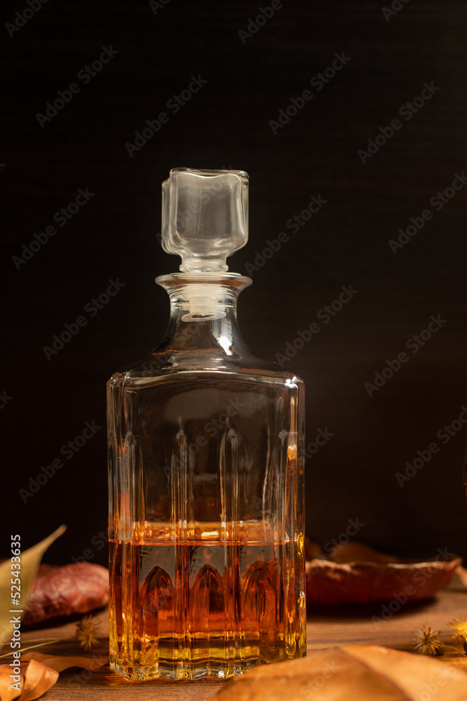 Rum, international rum day in autumn time, with dry leaves on wooden table Rum, international rum day in autumn time, with dry leaves on wooden table