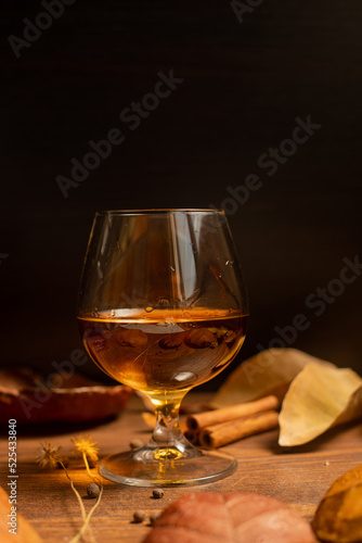 Rum, international rum day in autumn time, with dry leaves on wooden table
