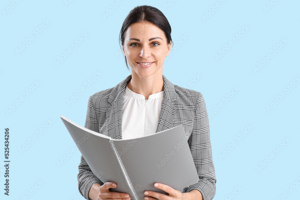 Female teacher with notebook on blue background Female teacher with notebook on blue background