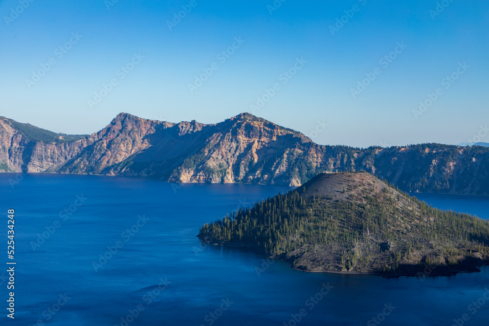 clear blue sky and blue waters of Crater Lake national park in Oregon during summer
