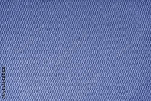 Texture of natural blue fabric or cloth. Fabric texture diagonal weave of natural cotton or linen textile material. Blue canvas background. Decorative fabric, curtain, furniture, walls, clothes