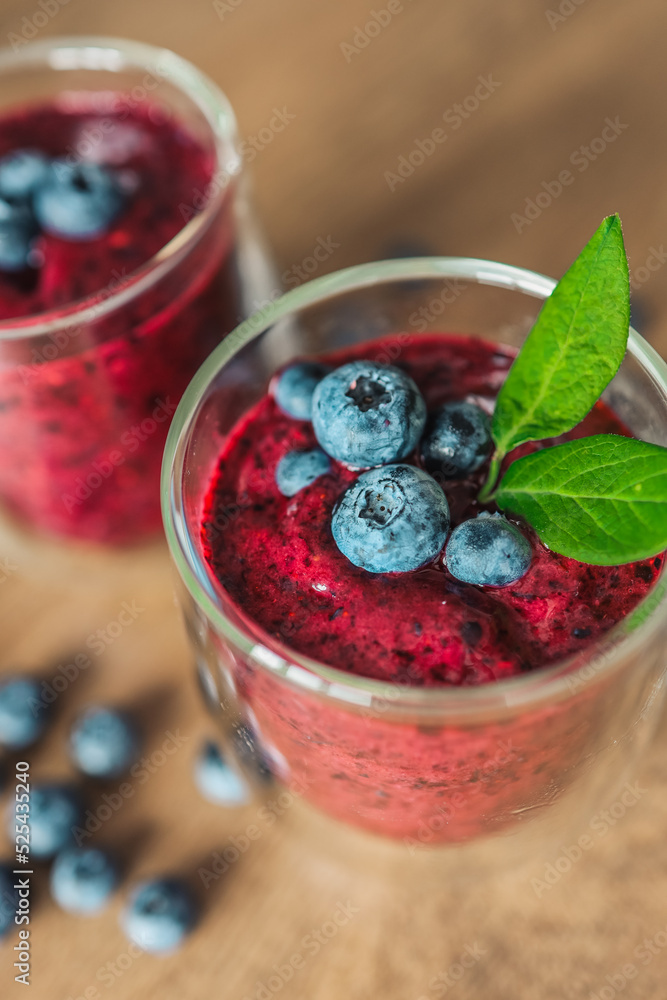 Fresh juicy blueberry smoothies in the glass. Simple background. Healthy food. Detox. Lifestyle Fresh juicy blueberry smoothies in the glass. Simple background. Healthy food. Detox. Lifestyle